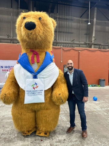 an adult man and a mascot